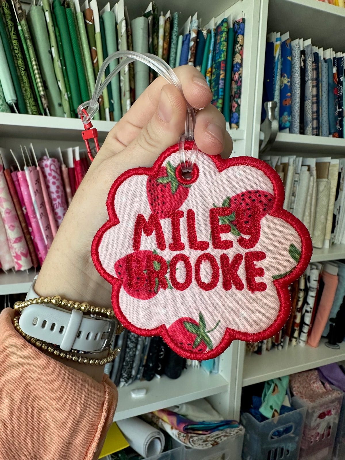 Red and white embroidered name tag